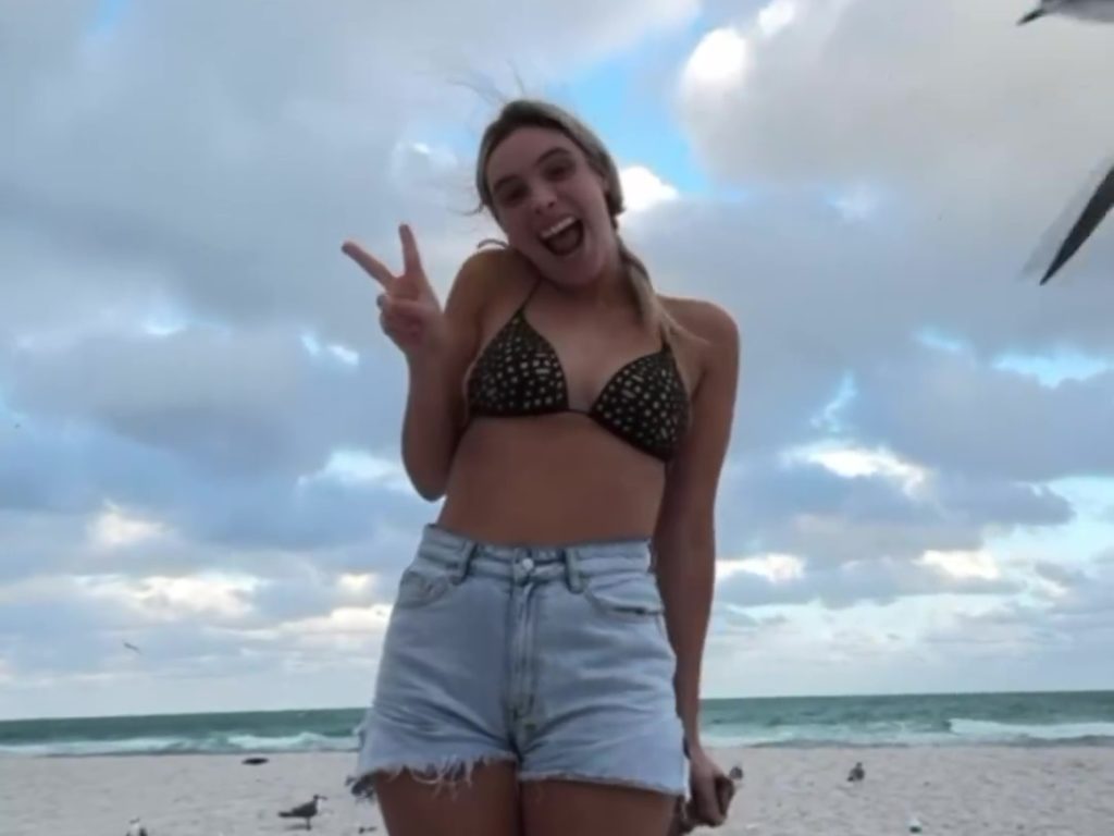 Influencerin Lele Pons zieht sich am Strand von einer Möwe aus, die ihren Bikini auszieht