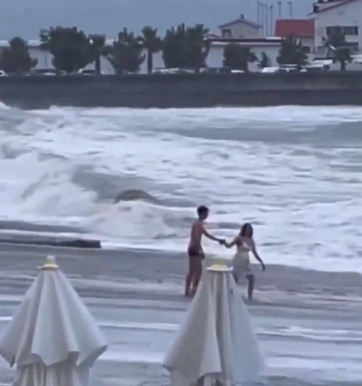 Besa a su novio en la playa, una ola monstruosa la mata: video viral